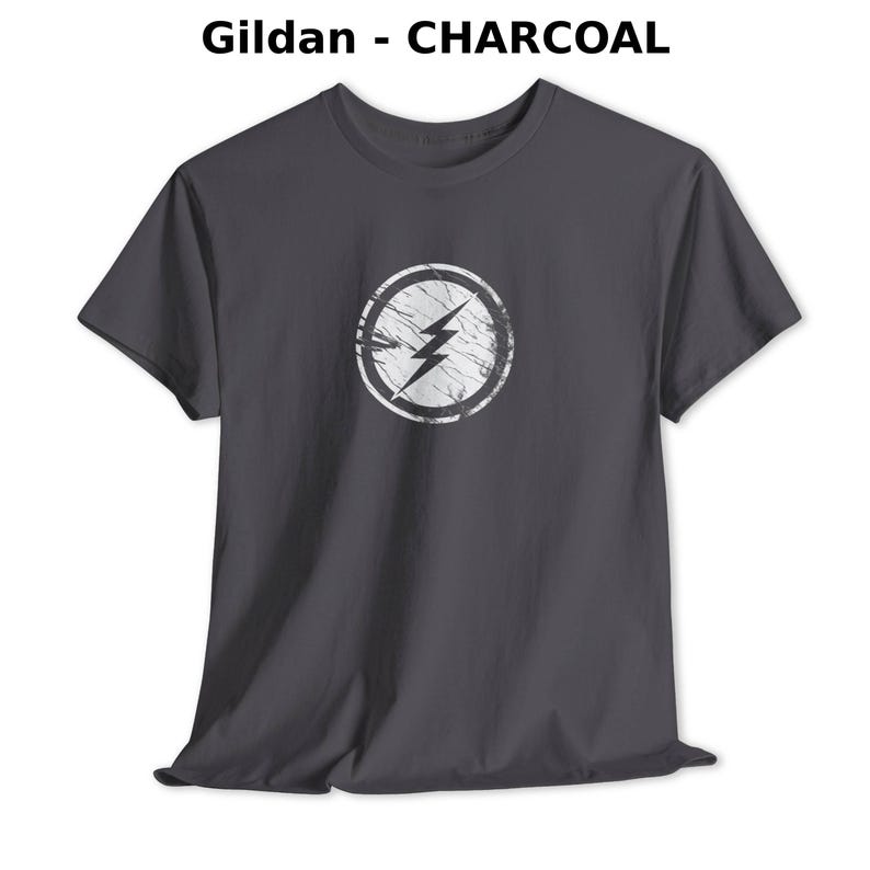 Distressed lightning bolt graphic t-shirt with circular emblem printed on ringer and classic cotton tees in multiple color options