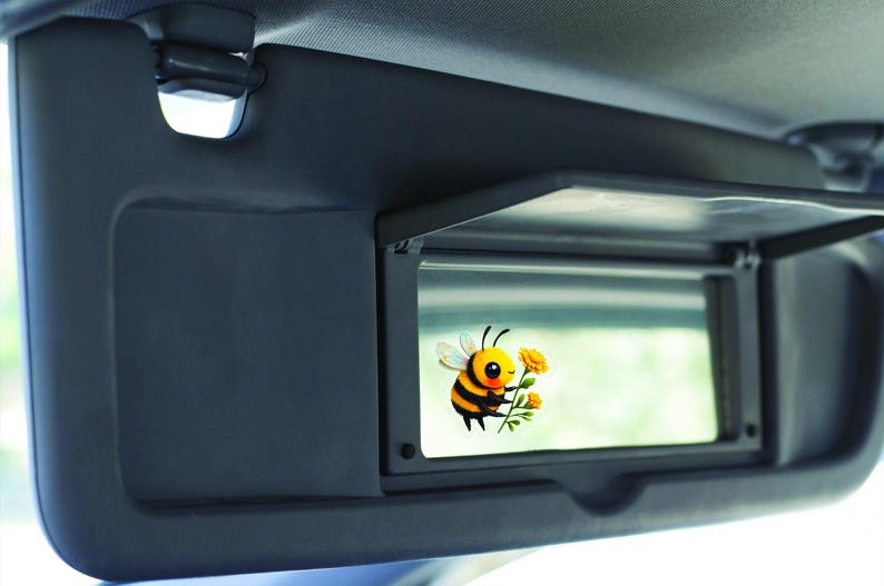 Adorable die-cut vinyl design of a fuzzy yellow honeybee holding a bright yellow flower. Shown as a fridge magnet displayed on a stainless steel refrigerator. This design is also available as a waterproof transparent sticker in five sizes. Ideal for decorating laptops, journals, water bottles, fridges, and more. Suitable for indoor and outdoor use.
