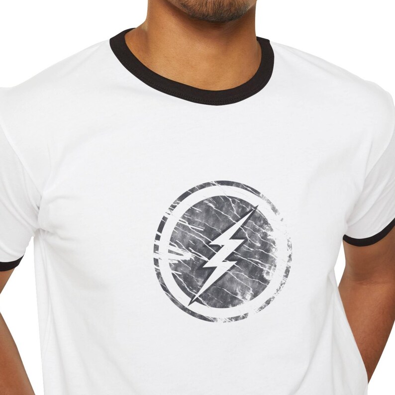 Distressed lightning bolt graphic t-shirt with circular emblem printed on ringer and classic cotton tees in multiple color options