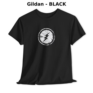 Distressed lightning bolt graphic t-shirt with circular emblem printed on ringer and classic cotton tees in multiple color options