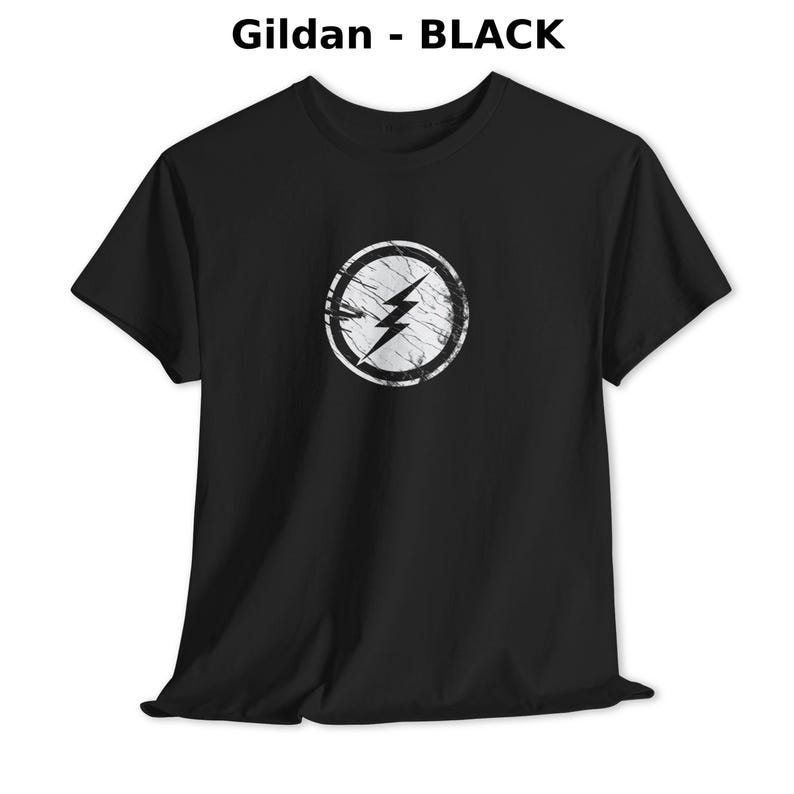 Distressed lightning bolt graphic t-shirt with circular emblem printed on ringer and classic cotton tees in multiple color options