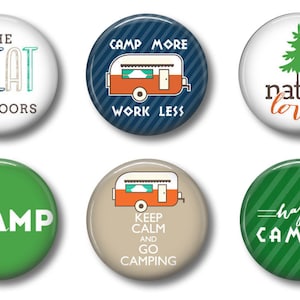 May include: Six round, colorful buttons with camping-themed designs. The buttons feature text such as "The Great Outdoors", "Camp More Work Less", "Nature Lover", "Camp", "Keep Calm and Go Camping", and "Happy Camper".