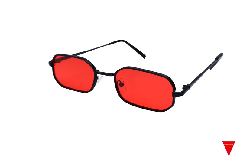 May include: Black framed sunglasses with red lenses. The lenses are rectangular and have a slight curve.