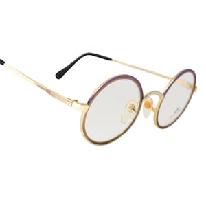 May include: Gold-tone round eyeglasses with purple accents on the rims. The glasses have clear lenses and black plastic temple tips.