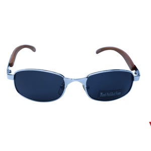 May include: Silver aviator sunglasses with dark lenses and brown wood arms. The sunglasses have the text "Hand Polished Frame" printed on the right lens.