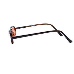 May include: A pair of eyeglasses with a dark brown tortoiseshell frame and orange-tinted lenses. The glasses are shown from a side profile, revealing the thin, curved temples and the rectangular shape of the frames. The design is simple and functional.