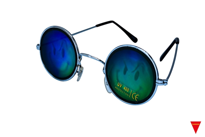 May include: Round, silver-framed sunglasses with blue, mirrored lenses. The lenses have a smiley face design and the text "UV 400 PROTECTION CE" is printed on the right lens.