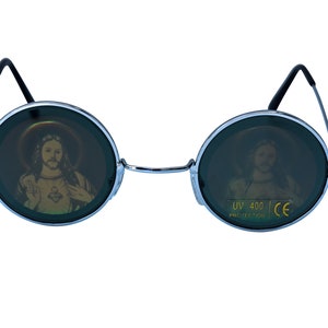 May include: Round sunglasses with a silver frame and dark green lenses. The lenses have a picture of Jesus on them. The sunglasses have UV 400 protection and CE certification.