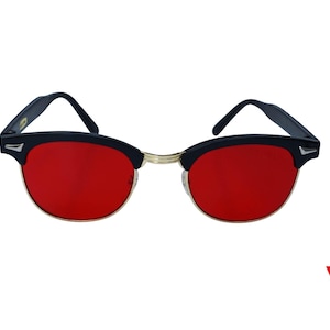 Peut inclure: Lunettes de soleil noires avec des verres rouges et une monture en métal doré.