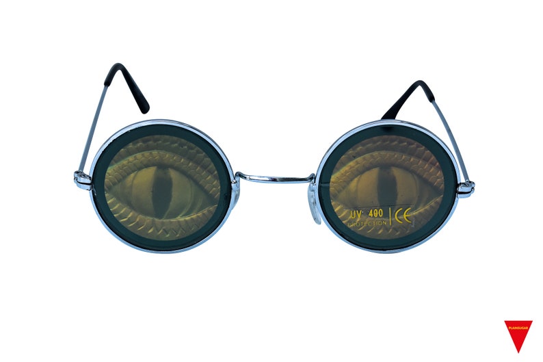 May include: Round silver-framed sunglasses with a black eye design on the lenses. The lenses have the text "UV 400 PROTECTION CE" printed on them.