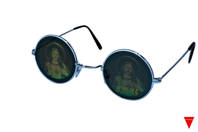 May include: Round, silver-framed sunglasses with dark green lenses. The lenses have a holographic image of a person with long hair and a beard. The text "UV 400 PROTECTION CE" is printed in yellow on the right lens.