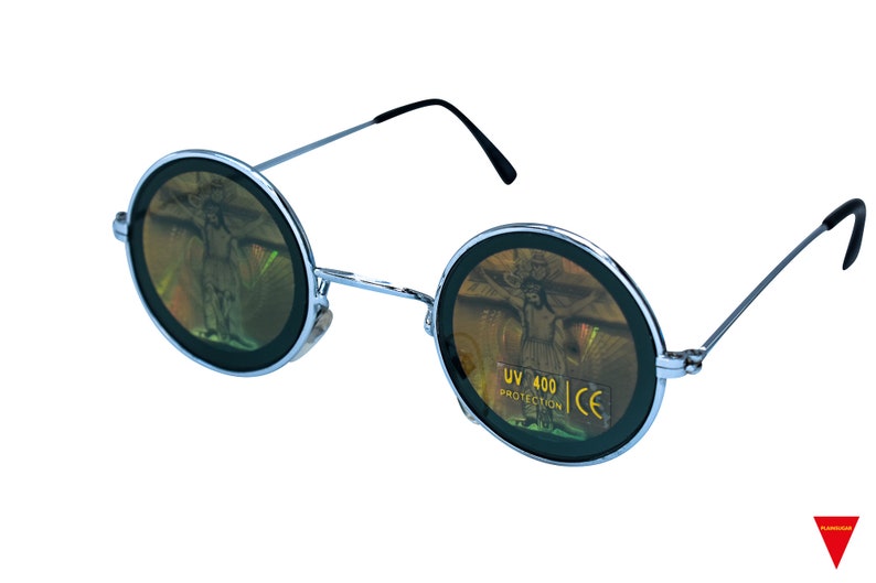 May include: Round, silver-framed sunglasses with a holographic, iridescent lens. The lens features a design of a person with outstretched arms. The sunglasses have a UV 400 protection label and CE marking.