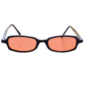 May include: Rectangular sunglasses featuring black frames and orange-tinted lenses. The temples have a tortoiseshell pattern on the inner side. A small red triangle logo with the text "PLAINSUGAR" is visible in the bottom right corner.