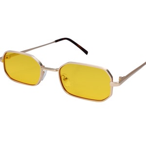 May include: Gold-framed sunglasses with yellow lenses. The frame has a rectangular shape with slightly rounded corners.