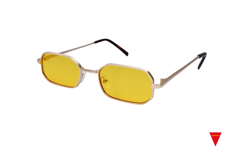 May include: Gold-framed sunglasses with yellow lenses. The frame has a rectangular shape with slightly rounded corners.