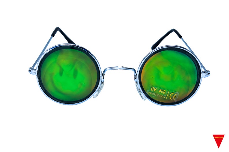 May include: Round, silver-framed sunglasses with green, iridescent lenses. The lenses have a subtle smiley face pattern. The right lens has the text "UV 400 PROTECTION CE" printed on it.