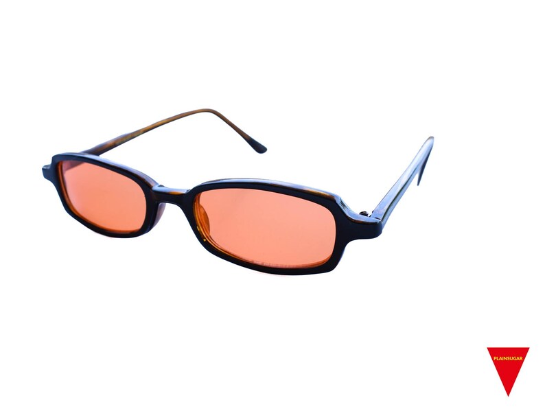 May include: Rectangular sunglasses featuring dark brown tortoise shell frames and vibrant orange tinted lenses. The eyewear has thin, matching brown arms that extend from the sides, providing a clear view of the front and side profile of the glasses.