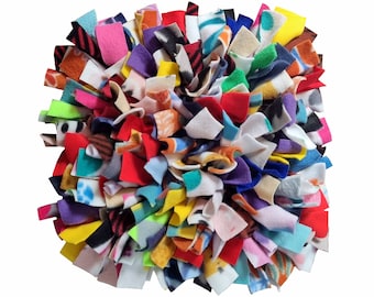 May include: A colourful dog enrichment mat with various fabric strips in different colours and patterns. The mat is designed to provide mental stimulation and entertainment for dogs.