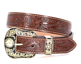 May include: A brown leather belt with a gold-tone buckle featuring a floral design. The buckle has a star and a horse head design. The belt is stitched with white thread.