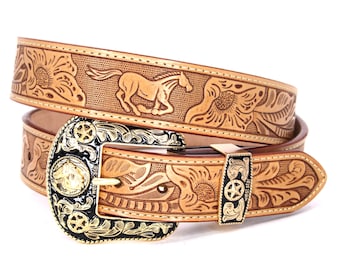 May include: A tan leather belt with an intricate floral and horse design. The belt buckle is gold-toned with black enamel and features a star design.
