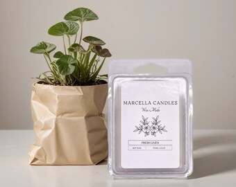 May include: A clear plastic package containing a wax melt with a white label that reads "Marcella Candles Wax Melts Fresh Linen 1oz 22.68g Soy Wax". The label also features a floral design.