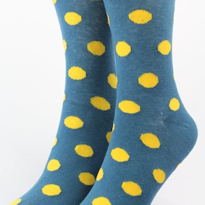 May include: A pair of blue socks with yellow polka dots. The socks are made of a soft, comfortable material and are perfect for everyday wear.