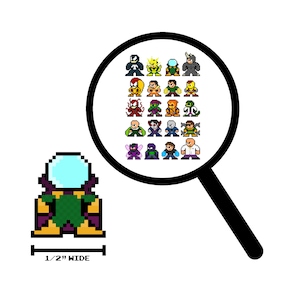 May include: A pixel art illustration of a green and yellow character with a large, clear dome head. The character is 1/2 inch wide. A magnifying glass shows a grid of 25 pixel art characters, including Spider-Man, Venom, and Green Goblin.