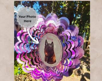 May include: A purple and blue scalloped metal wind spinner featuring a central circular insert with a photograph of a dark-furred dog, the name Darcy, and text. A silver star-shaped tag with the text Your Photo Here is attached.