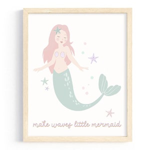 May include: A framed print with a pink mermaid with a green tail and the text "make waves little mermaid". The mermaid is surrounded by pink and blue stars and bubbles.