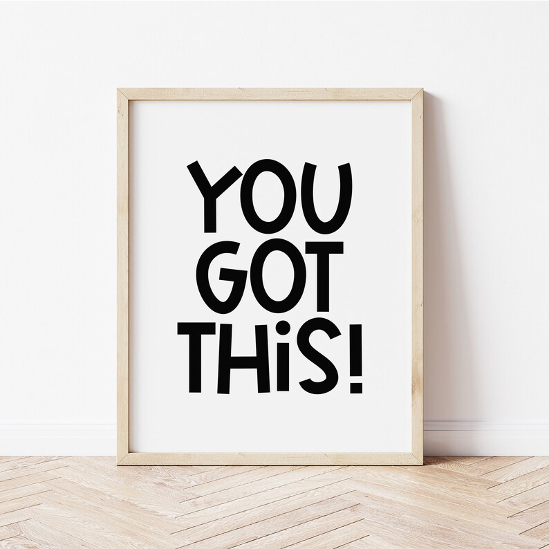 May include: A framed print with a white background and black text that reads "YOU GOT THIS!" in a playful, bold font.