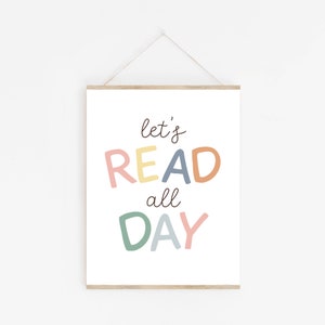 May include: A white printable poster with the text "let's READ all DAY" in colorful letters. The letters are in shades of pink, yellow, orange, blue, and green.