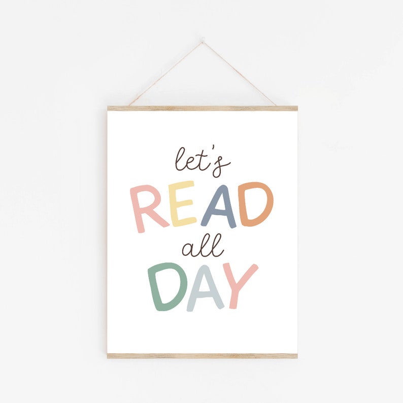 May include: A white printable poster with the text "let's READ all DAY" in colorful letters. The letters are in shades of pink, yellow, orange, blue, and green.