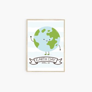 May include: A framed Earth Day print featuring a smiling Earth character with arms and legs, waving. The Earth is light blue with green continents. The banner below reads "Earth Day April 22" on a light blue striped background.