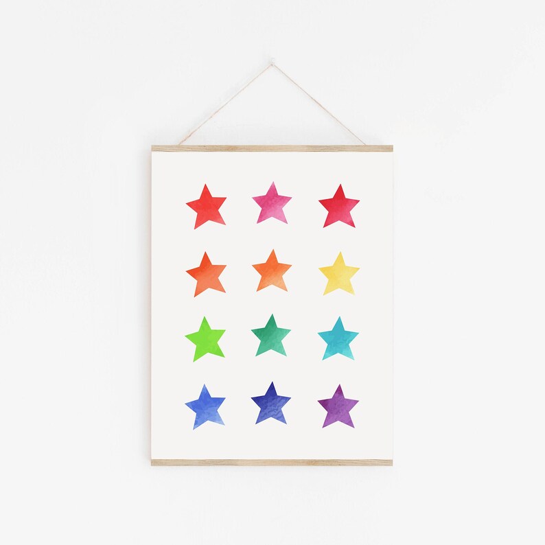 May include: A framed print with a rainbow of watercolor stars. The stars are arranged in three rows of four stars each. The stars are red, orange, yellow, green, blue, indigo, and violet.