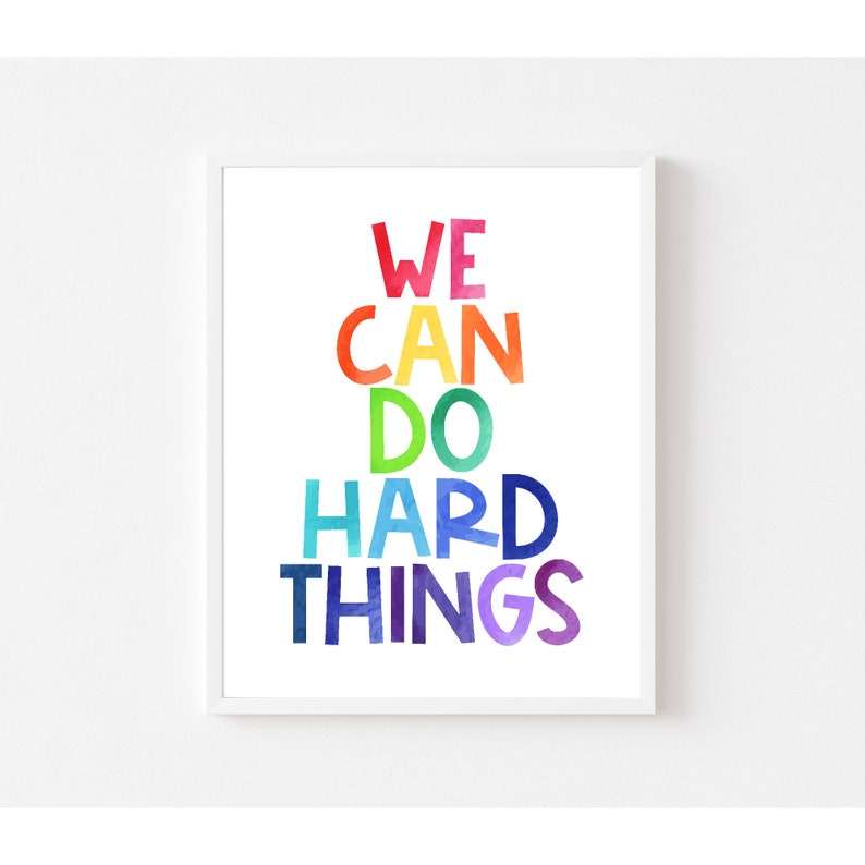 May include: A motivational poster with the text "WE CAN DO HARD THINGS" in rainbow colors. The words are stacked on top of each other, with each word in a different color of the rainbow.