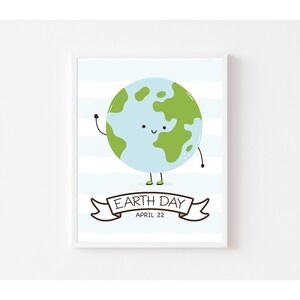 May include: A framed Earth Day print featuring a cartoon globe with a smiling face, waving arm, and tiny green shoes. The background has blue and white stripes. A banner below reads "Earth Day April 22."
