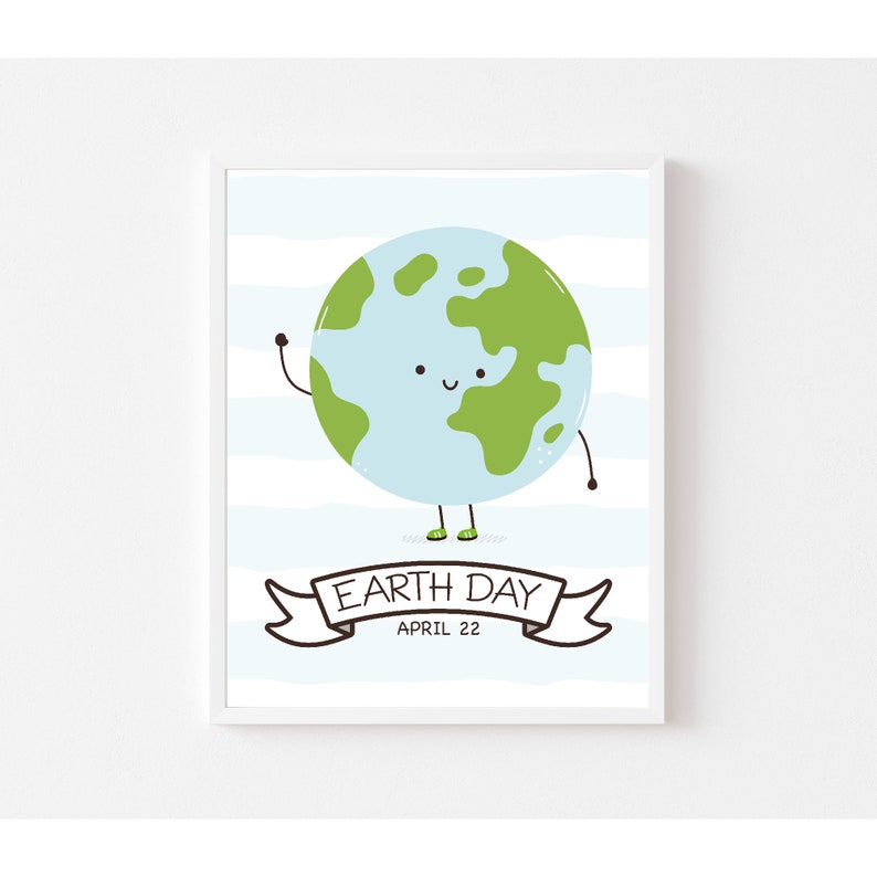 May include: A framed Earth Day print featuring a cartoon globe with a smiling face, waving arm, and tiny green shoes. The background has blue and white stripes. A banner below reads "Earth Day April 22."