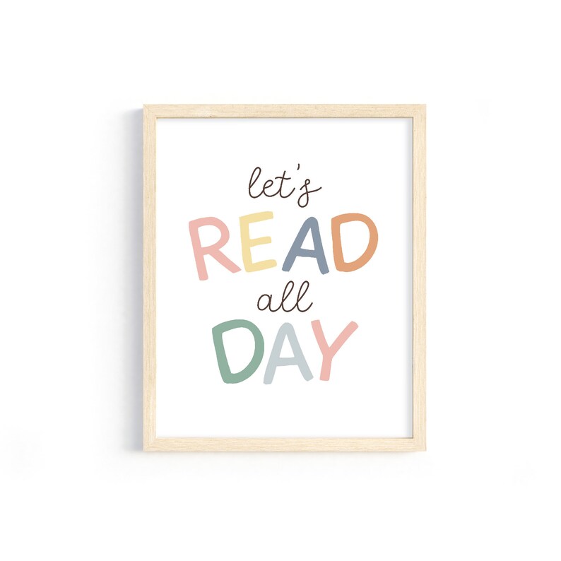 May include: A framed print with the text "let's READ all DAY" in colorful letters. The letters are in shades of pink, yellow, orange, blue, and green.