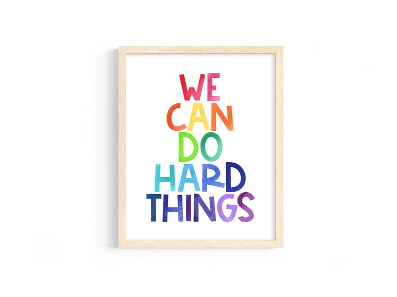 May include: A framed print with the text "WE CAN DO HARD THINGS" in a rainbow color scheme.
