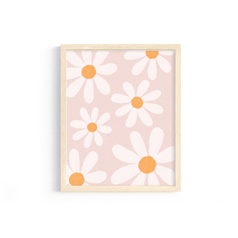 May include: A framed print with a pink background and a pattern of white daisies with orange centers.
