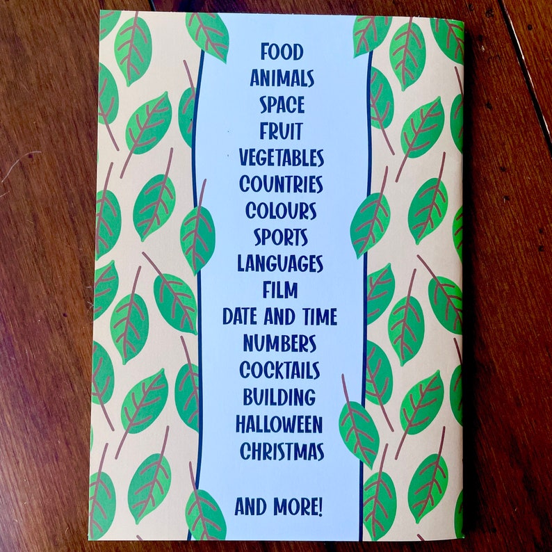 May include: A book cover with a green and brown leafy pattern. The text on the cover reads "FOOD, ANIMALS, SPACE, FRUIT, VEGETABLES, COUNTRIES, COLOURS, SPORTS, LANGUAGES, FILM, DATE AND TIME, NUMBERS, COCKTAILS, BUILDING, HALLOWEEN, CHRISTMAS, AND MORE!"
