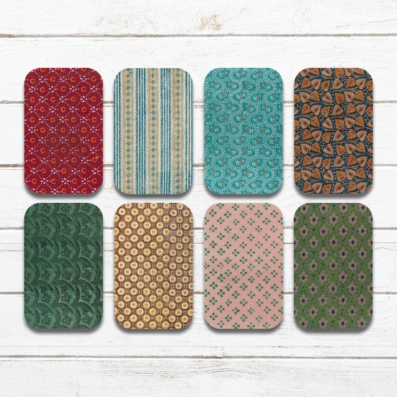 May include: Eight rectangular coasters with rounded corners, each featuring a unique vintage-style pattern. The patterns include floral, striped, and geometric designs in various colors such as red, teal, and gold. The coasters are arranged on a white wooden surface.