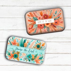 May include: Two rectangular decorative items with floral designs. One features the text "GIVE IT TO GOD" on a white banner, surrounded by orange, red, and green flowers. The other has "Praise the Lord" on a teal banner, with orange and teal flowers.