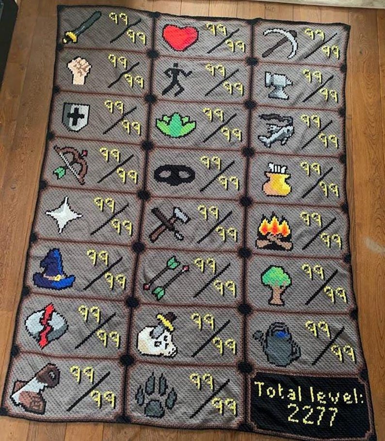 Puede incluir: Una manta de ganchillo gris y negra con iconos pixelados, incluyendo una espada, un coraz&oacute;n y un &aacute;rbol. Cada icono est&aacute; emparejado con el n&uacute;mero 99 y una barra. La manta tiene un borde y el texto "Total level: 2277".
