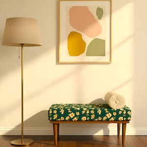 May include: Interior shot with a floor lamp, abstract art print, and a floral bench. The bench has a green floral pattern with yellow flowers and a beige bolster cushion. The artwork features abstract shapes.