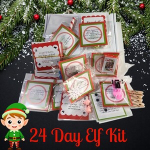 May include: A 24 Day Elf Kit with various small gifts and cards. The cards have red and green borders and include jokes and activities. The kit includes a snowflake, playing cards, and pink accessories. The text "24 Day Elf Kit" is displayed.