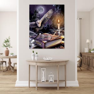 May include: A rectangular wall art print featuring a snowy owl in flight above a thick book titled The Magic. The scene includes round spectacles resting on the book, a glowing candle in a holder, and a wand, all set against a dark night sky.