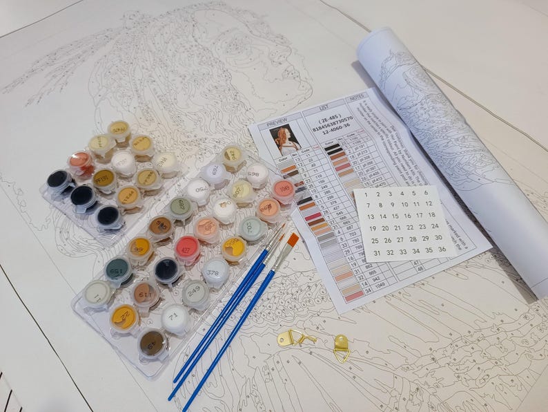 a white table topped with lots of crafting supplies