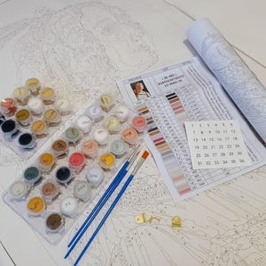 a white table topped with lots of crafting supplies