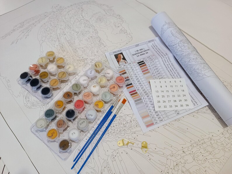 a white table topped with lots of crafting supplies
